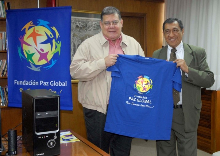 Two men are holding up a t-shirt with the logo of Viceministerio de Culto, symbolizing a donation campaign.