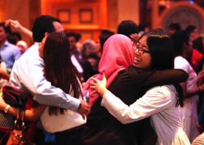Young leaders, volunteers, and participants embrace each other at the conclusion of the Global Youth Fest.