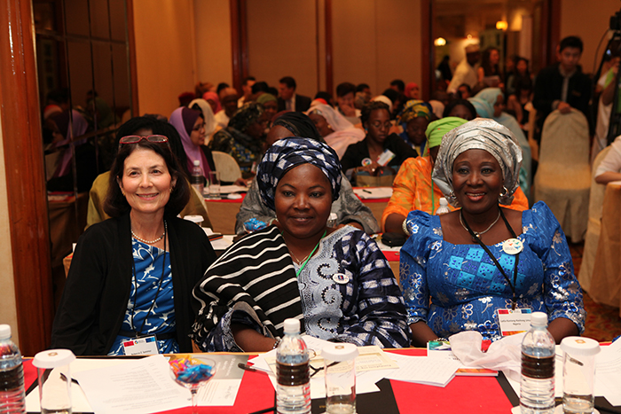 Mrs. Rebecca Sommer, co-founder of GPW's Cookstove Project and Nigerian women delegates attend the women's session, "Toward an Ethic of Compassion and Cooperation."