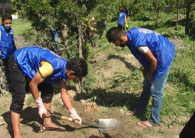 Global Peace Foundation volunteers clean Guheshwori Peace Park.