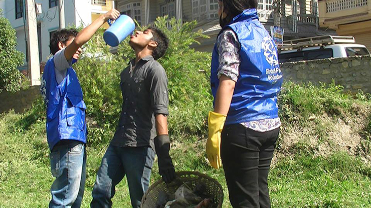 Global Peace Foundation volunteers clean Guheshwori Peace Park.