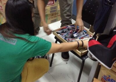 Volunteers organize and package school supplies.