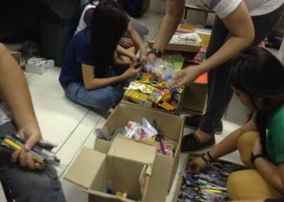 Volunteers organize and package school supplies.