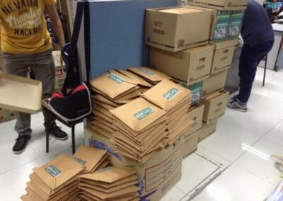 Volunteers organize and package school supplies.
