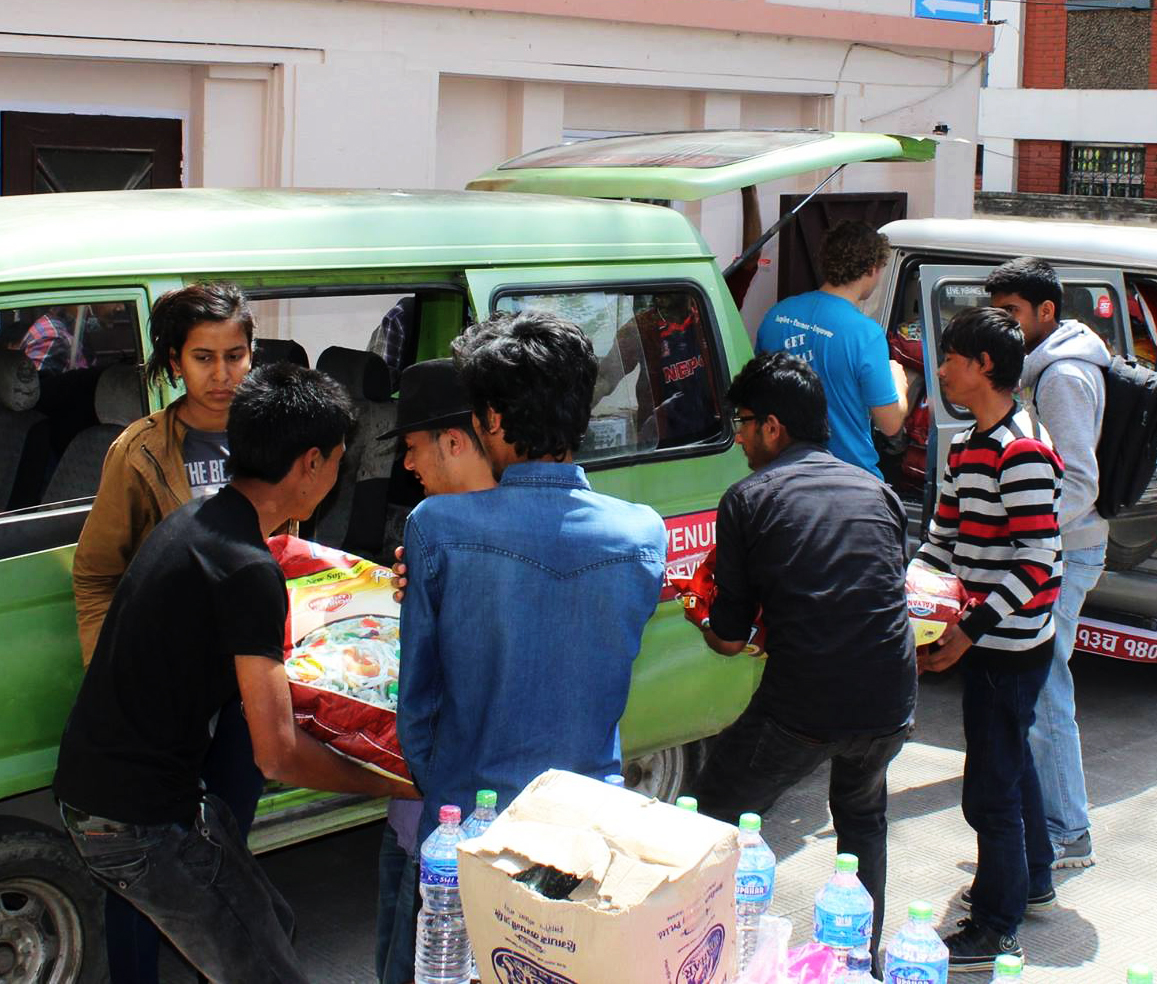 Volunteers loading food and water to distribute to displaced families.
