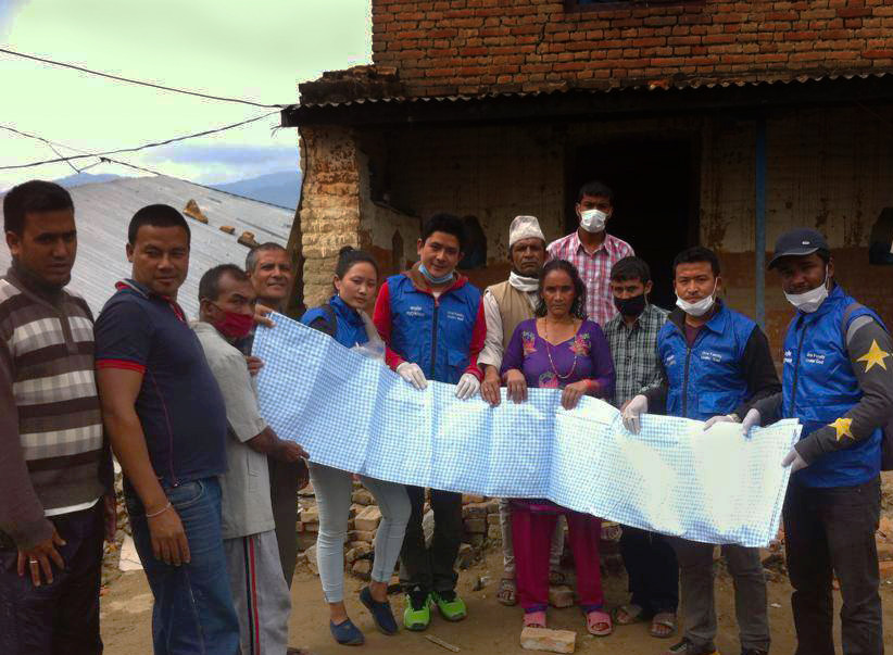Rise Nepal volunteers distribute tarps, water and food