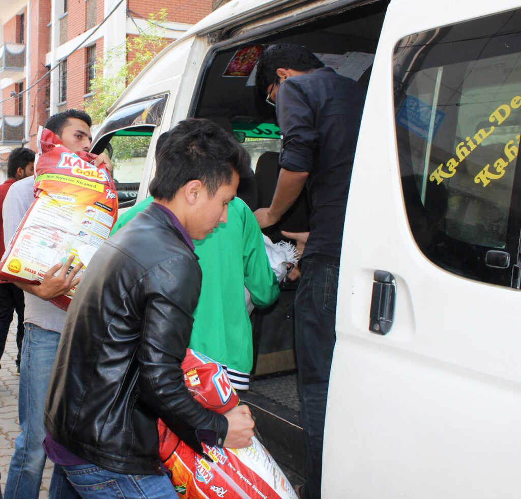 Volunteers load vans with food supplies