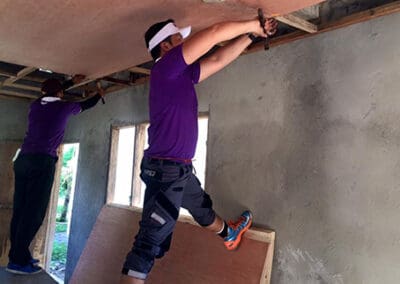 Global Peace Foundation volunteer restore ceiling of community center.