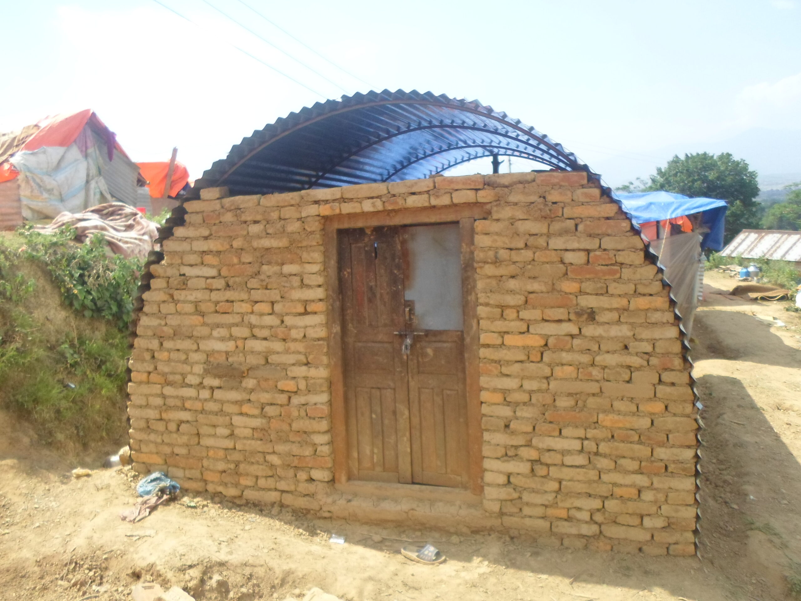 Global Peace Foundation volunteers and village locals build transitional shelters.