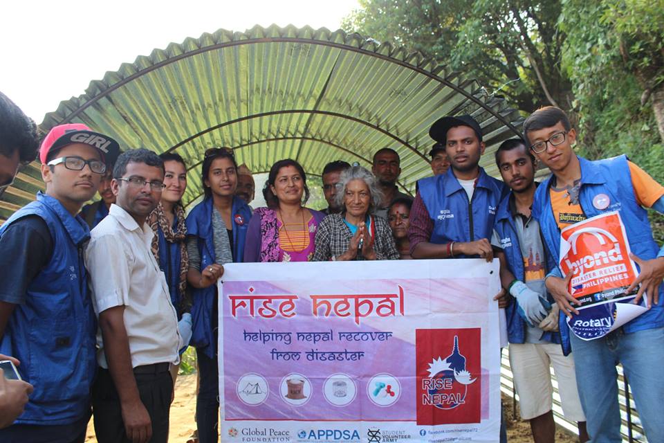 Global Peace Foundation volunteers and Okkharpauwa locals inside a transitional shelter.