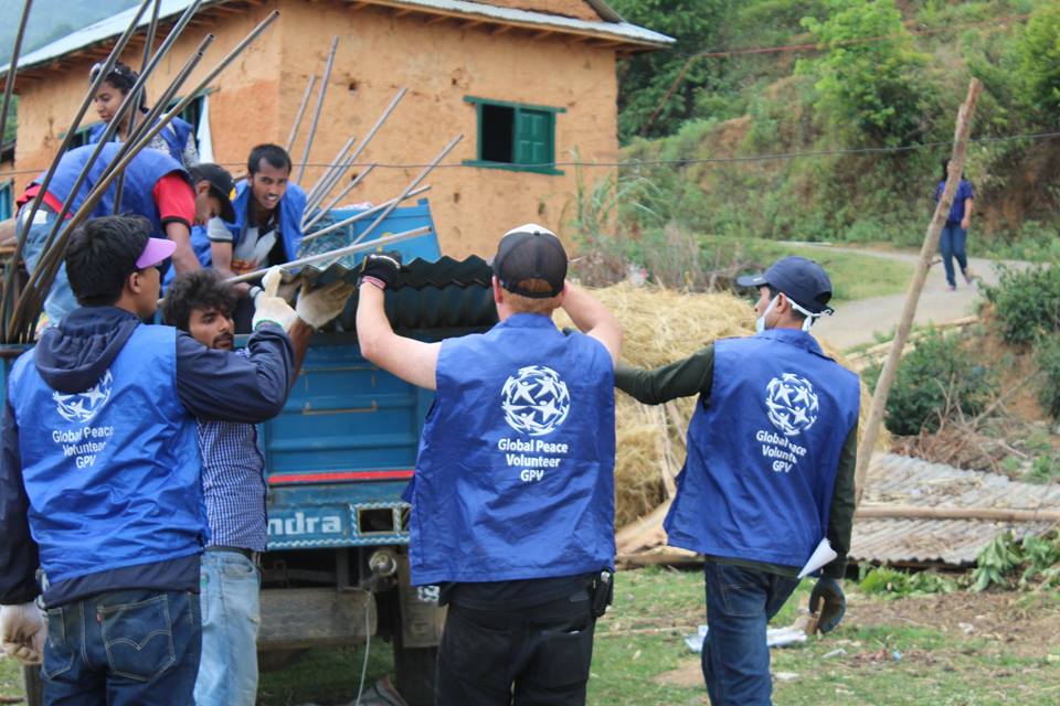 Global Peace Foundation Volunteers unload materials for transitional shelters.