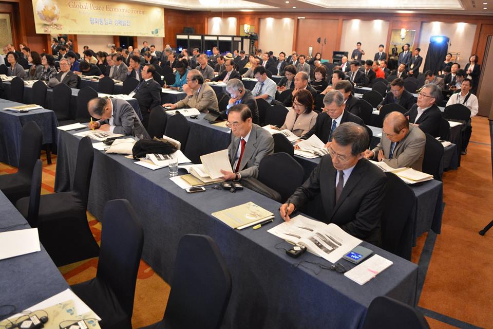 Delegates read through presentations from speakers on the role and advancements of the economy in peaceful unification.