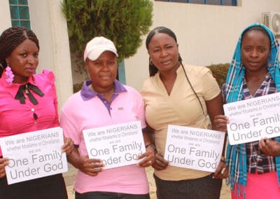 A family under God holding campaign signs.