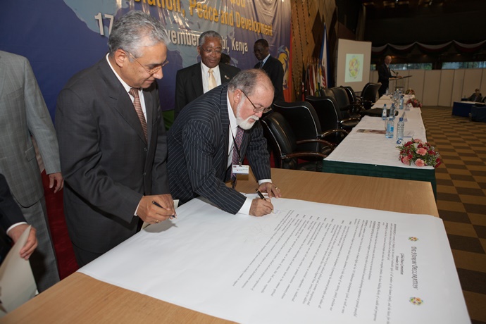 Sir James Mancham signs the Nairobi Declaration.