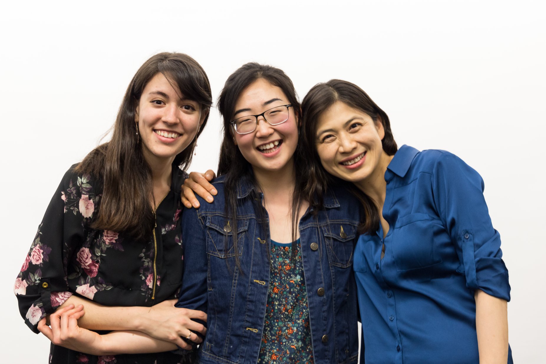 Three women smiling together at the camera