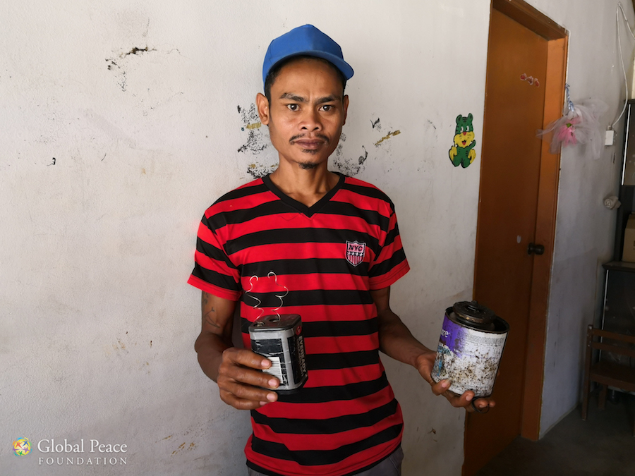 Villager holds 6v battery and kerosene used for fuel