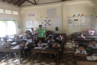 Volunteer teacher Aing in his classroom with his students