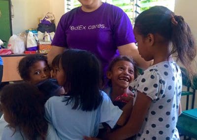 Global Peace Foundation Volunteer and local children share a moment of bonding.