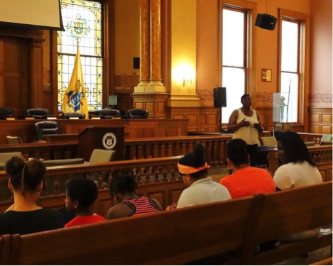 Detective Doris Johnson speaks at City Hall with JCCCE youth