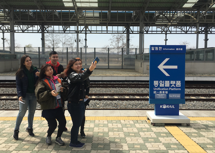 International group pause for a selfie at an empty platform at Dorasan Station
