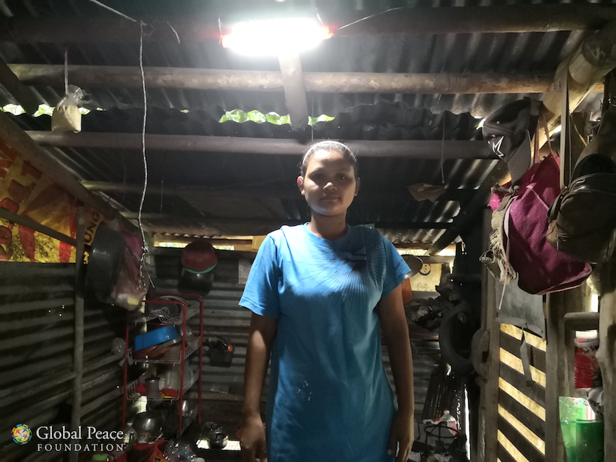 Mother stands in solar lit kitchen