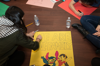 Volunteers create posters for local elementary school
