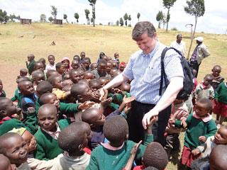 The author meets children outside the school.