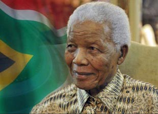 Nelson mandela in front of the south african flag.