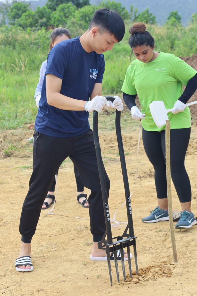 Volunteer tilling the soil