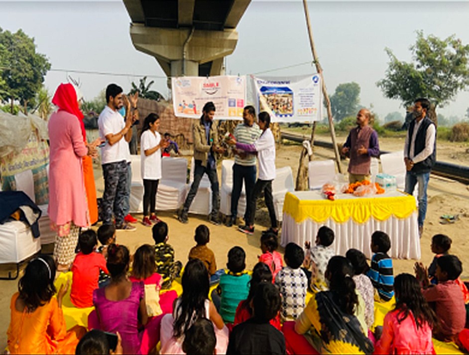 Volunteers presenting to a crowd of children