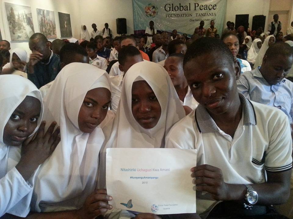 Tanzanian Youth Pose with #PeaceDay Sign at Celebration
