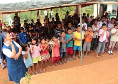 Local children at Sitio Pureg welcome the international team with song