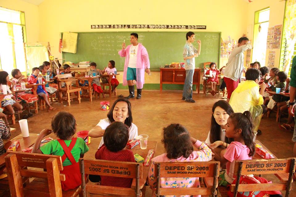 International volunteers teach an oral hygiene class.