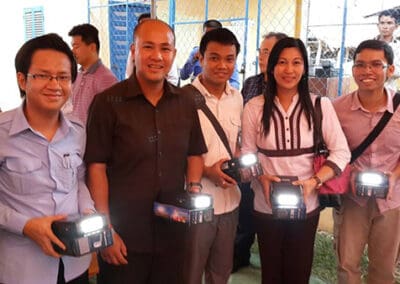 H.E. Hun and members of the Global Peace Foundation with solar lamps.