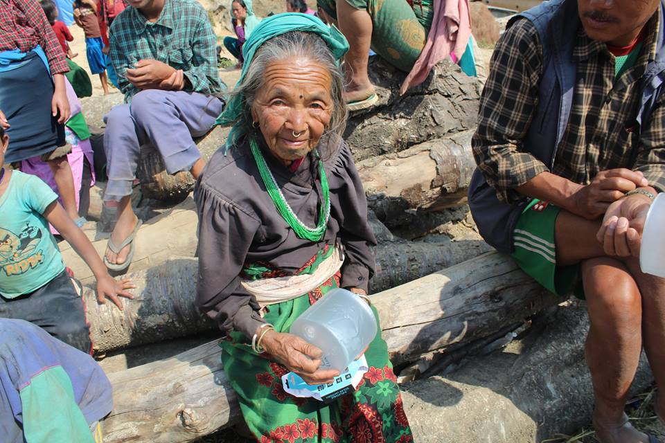 Global Peace Foundation distributes solar lamp to Nepal earthquake victims.