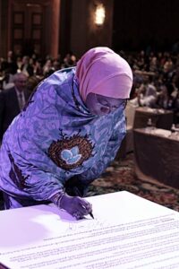 Hajiya Aminda Namadi Sambo signs 2013 Kuala Lumpur Peace Resolution.