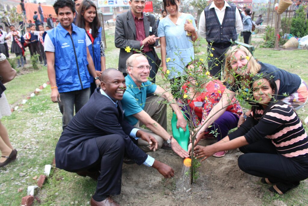 Partners plant a tree at Bagmati River clean up
