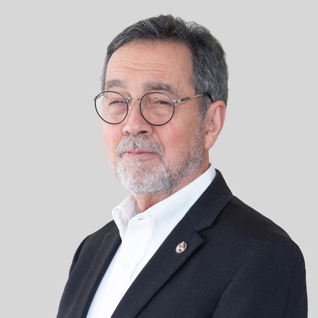 Mr. John Dickson, a man wearing glasses and a suit, is posing for a photo.