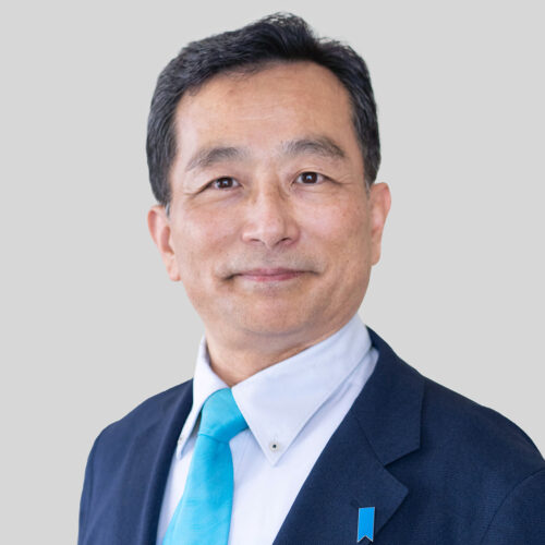Mr. Kenji Sawai, a man in a suit and a blue tie.