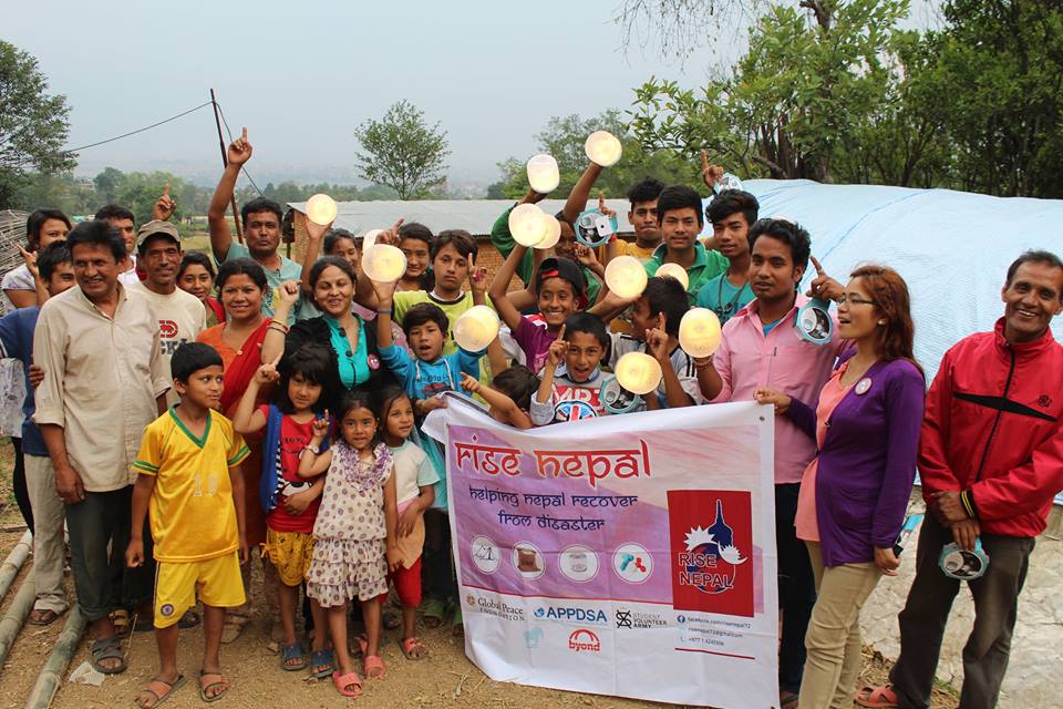 Global Peace Foundation distributes solar lamps to Nepal students after earthquake.