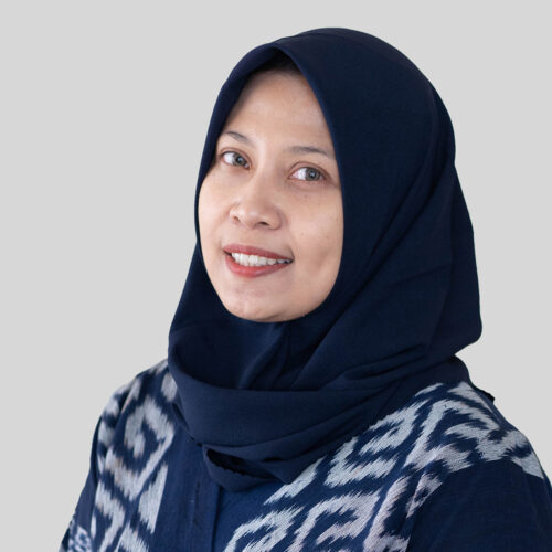 A woman in a blue hijab smiling at the camera, Ms. Shintia Utami.