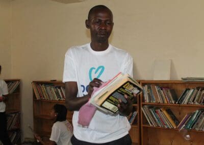 Volunteer wipes a book