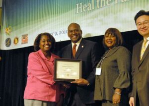 Senator Emanuel Jones presents awards to significant leaders at the Strengthening Families and Communities Coalition Summit in Atlanta, Georgia.