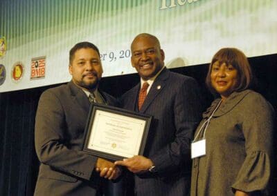 Senator Emanuel Jones presents awards to significant leaders at the Strengthening Families and Communities Coalition Summit in Atlanta, Georgia.