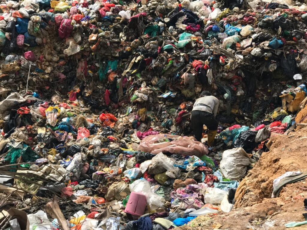 Villagers scavenging through piles of trash at a landfill near Kg. Bukit Biru.