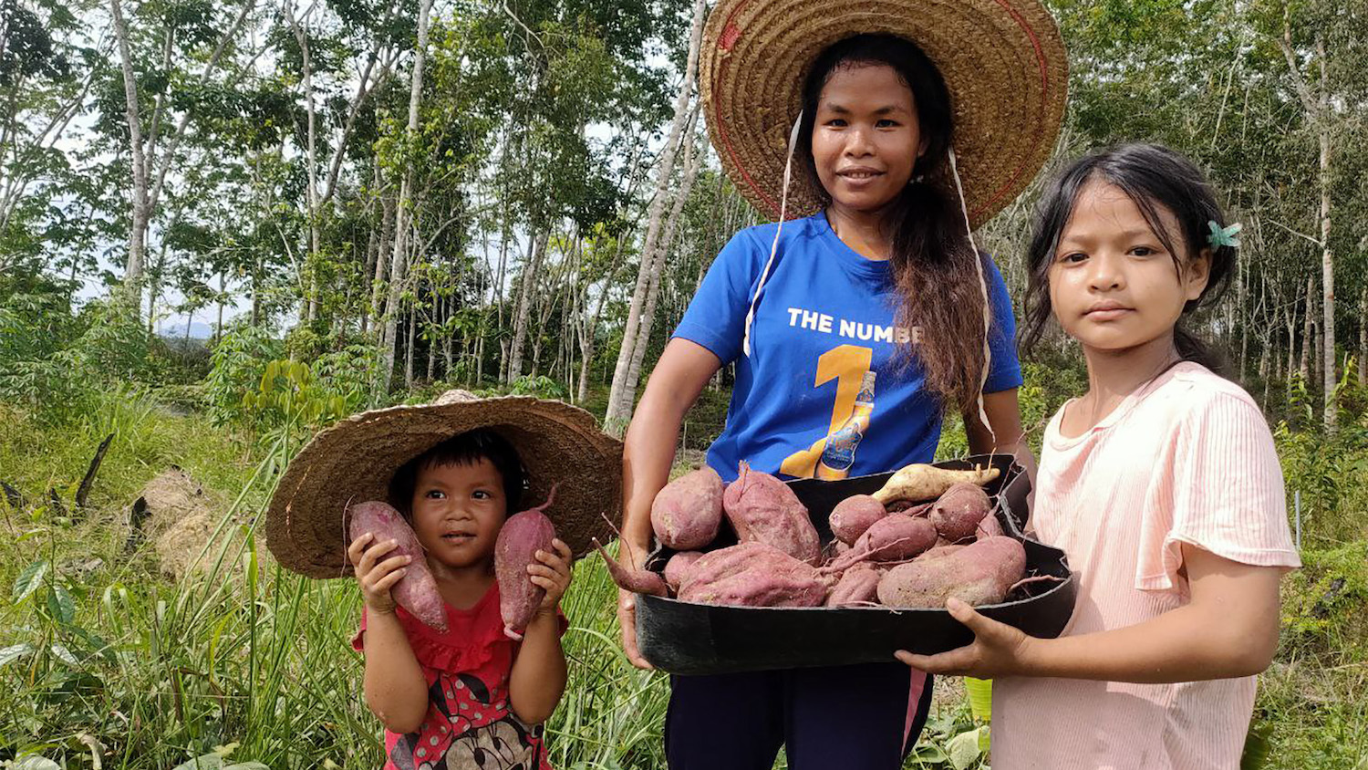 Orang Asli Amai proudly showing their harvested organic produce which include a variety of vegetables