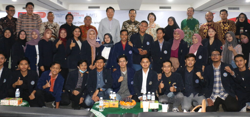 A group of people posing for a picture at GPF Indonesia's UGen Seminar.