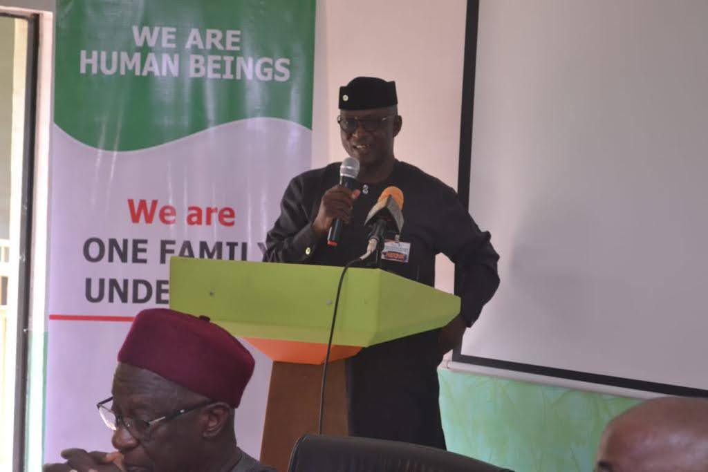 A man is speaking at a meeting about human rights during an Interfaith Roundtable supporting religious collaboration in Nigeria.