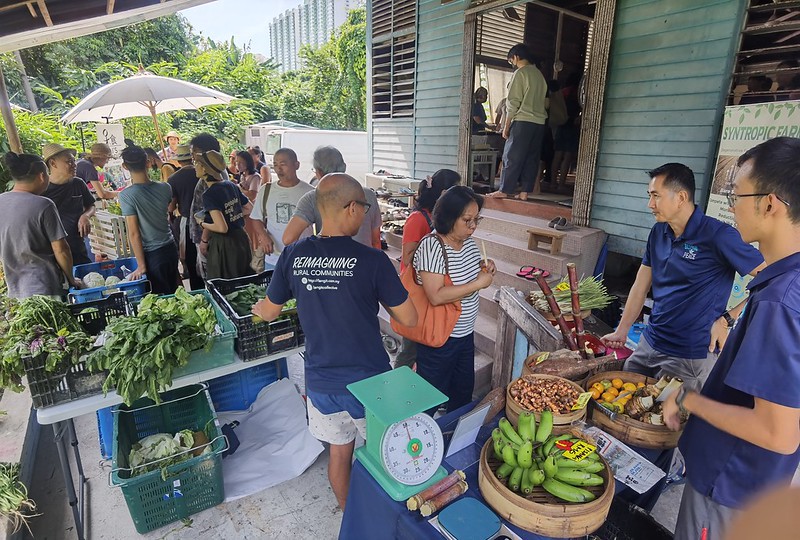 Global Peace team selling Kebun Amai produce at organic markets