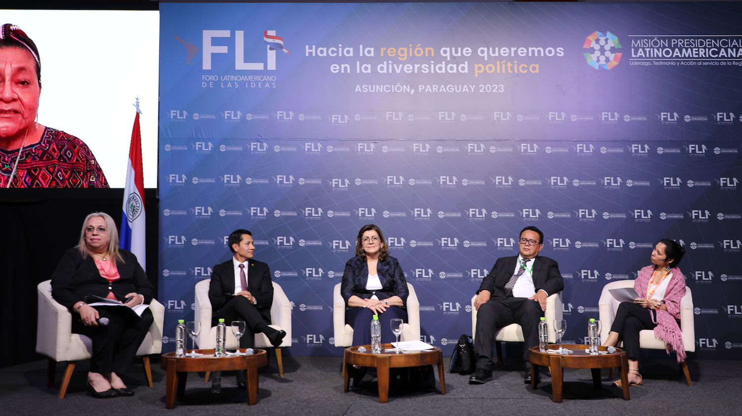 A group of people sitting on a stage engaged in dialogue at the Latin American Forum of Ideas.